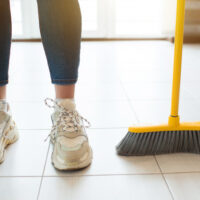 Cleaning floor with brush