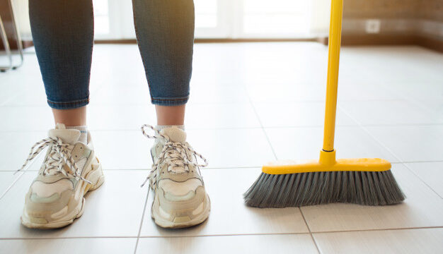 Cleaning floor with brush