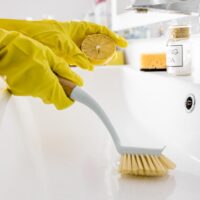 Cleaning wash basin with lemon