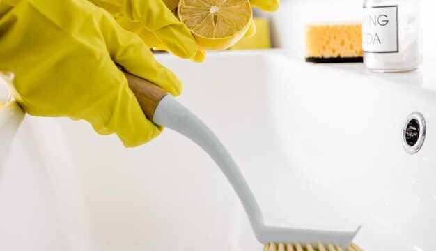 Cleaning wash basin with lemon